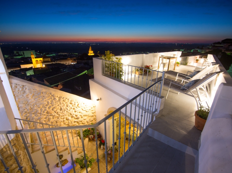 At night, the house takes on another kind of beauty with each of the terraces illuminated against the glow of the exposed fortress walls and the lights of the coast twinkling in the distance 