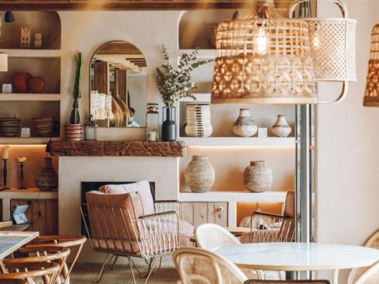 Nature-inspired color palette, handwoven rattan pendant lights, arched wall niches, rustic ceramic vases, natural wood textures, arched mirror centerpiece