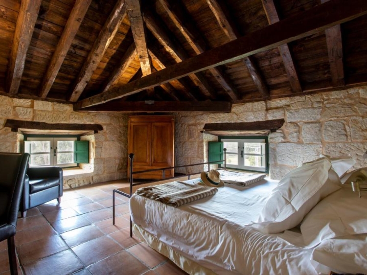Attic bedroom, Wooden ceiling, Stone walls, Rustic style, Cozy bed