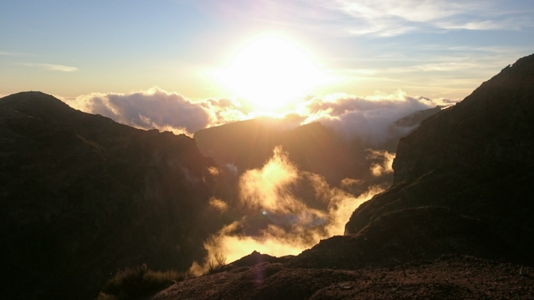 Sun breaking through the fog in the mountains